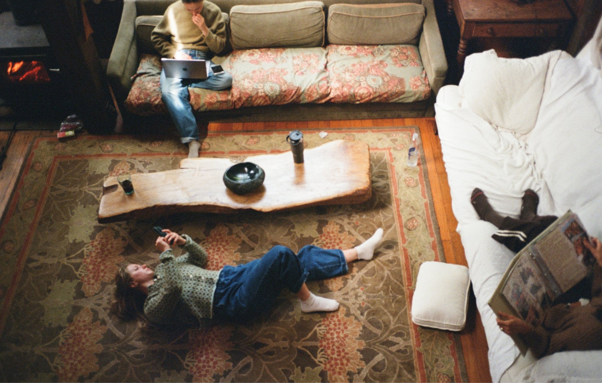 Everyday life documented with 35mm film photography as friends relax together in a cozy living room.