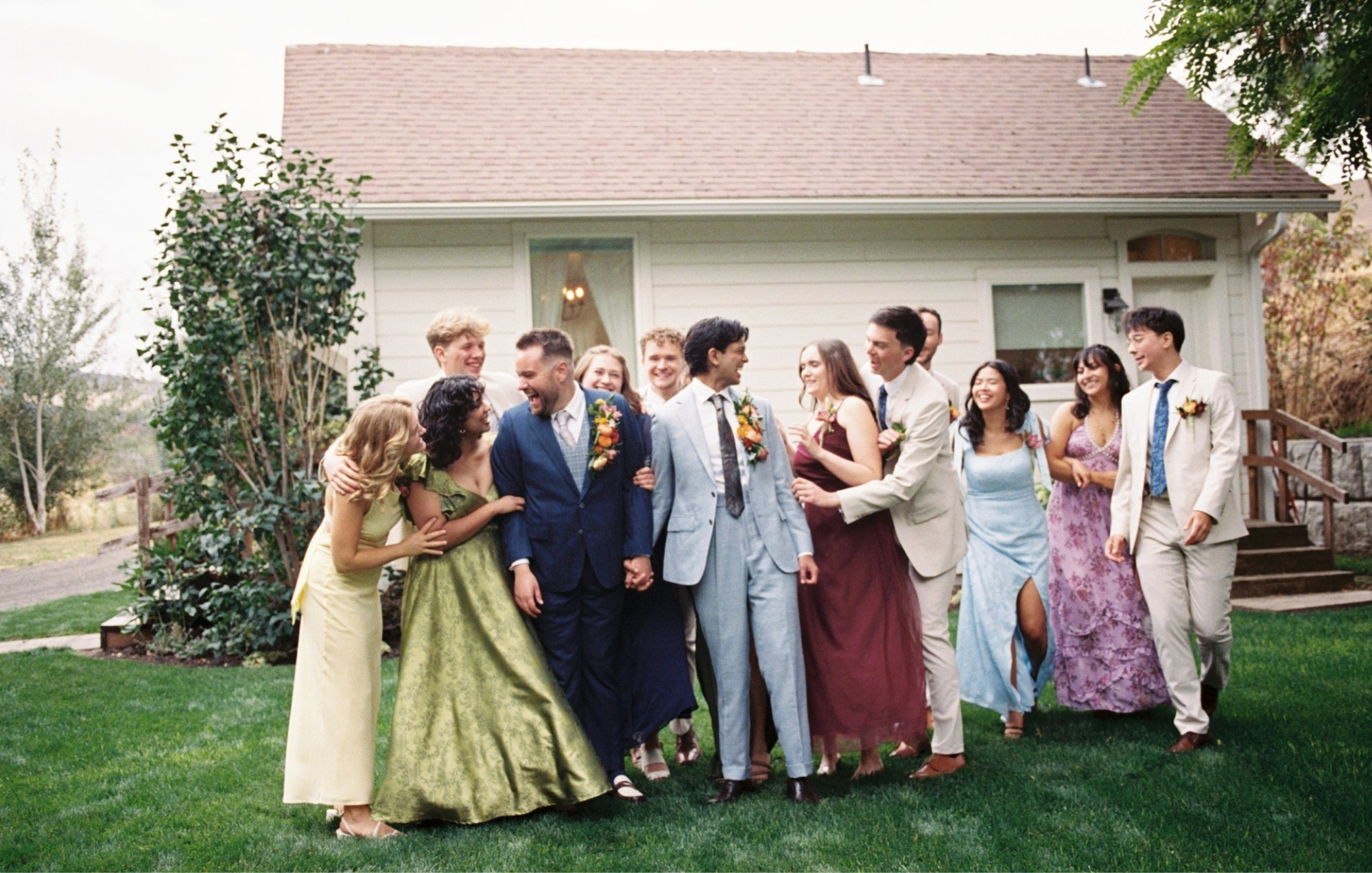 friends and family celebrating two grooms on their wedding day
